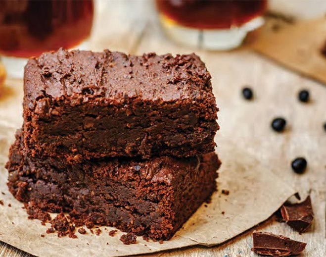 Stacked chocolate brownies on parchment paper