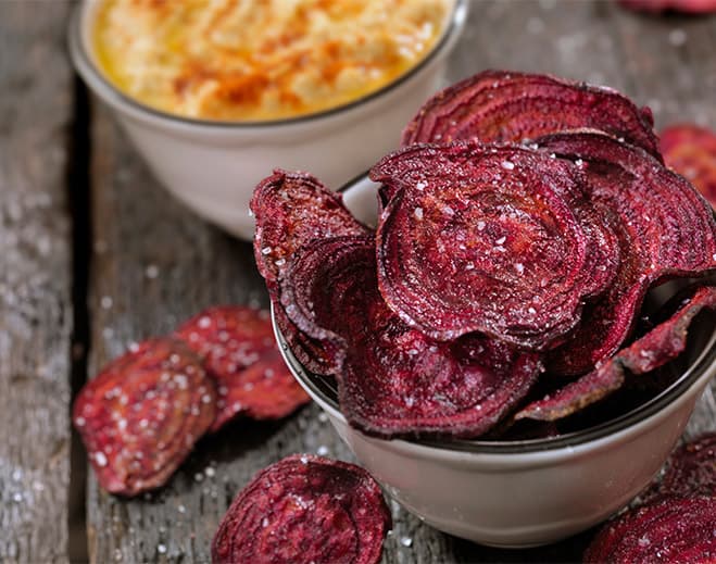 Bowl of crispy beet chips with dip